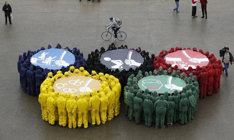 Olympic rings are displayed with images against restriction of speech and freedom of information, repression of demonstrations, discriminati Olympic rings are displayed with images against restriction of speech and freedom of information, repression of demonstrations, discriminati