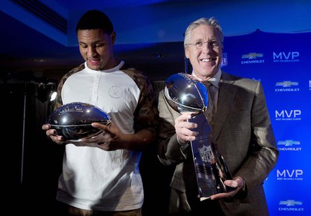 Seattle Seahawks linebacker and Malcolm Smith (L) looks at his Most Valuable Player trophy as head coach Pete Carroll holds the Vince Lombar Seattle Seahawks linebacker and Malcolm Smith (L) looks at his Most Valuable Player trophy as head coach Pete Carroll holds the Vince Lombar