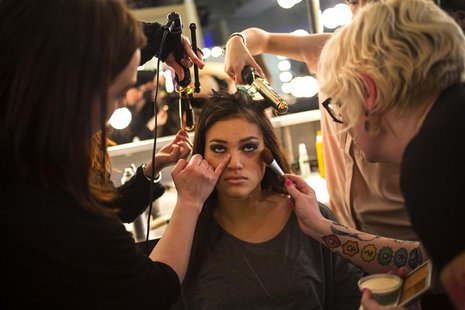 A model has make up applied before the GS Shop Lingerie Show featuring Wonderbra, Anna Sui and Spanx Fall 2014 collections during New York F A model has make up applied before the GS Shop Lingerie Show featuring Wonderbra, Anna Sui and Spanx Fall 2014 collections during New York F