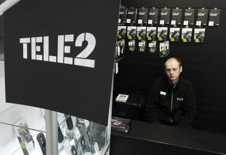 A shop assistant looks on from inside a Tele2 company's sales office in St. Petersburg, March 28, 2013. REUTERS/Alexander Demianchuk A shop assistant looks on from inside a Tele2 company's sales office in St. Petersburg, March 28, 2013. REUTERS/Alexander Demianchuk