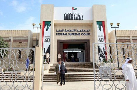People stand outside the federal supreme court in Abu Dhabi November 27, 2011. REUTERS/Nikhil Monteiro People stand outside the federal supreme court in Abu Dhabi November 27, 2011. REUTERS/Nikhil Monteiro