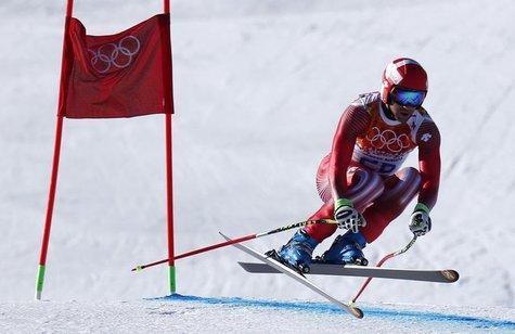 Switzerland's Didier Defago clears a gate in the first training session for the men's alpine skiing downhill event during the 2014 Sochi Win Switzerland's Didier Defago clears a gate in the first training session for the men's alpine skiing downhill event during the 2014 Sochi Win