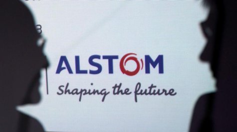 People are silhouetted in front on an Alstom logo during a news conference to present the group's first half results at the company headquar People are silhouetted in front on an Alstom logo during a news conference to present the group's first half results at the company headquar