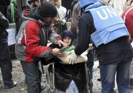 Residents receive food aid distributed by the U.N. Relief and Works Agency (UNRWA) at the besieged al-Yarmouk camp, south of Damascus Februa Residents receive food aid distributed by the U.N. Relief and Works Agency (UNRWA) at the besieged al-Yarmouk camp, south of Damascus Februa