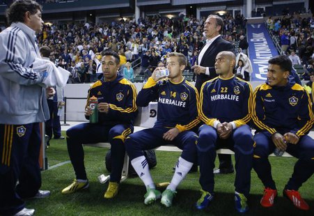 Los Angeles Galaxy midfielder Robbie Rogers (14) sits on his team bench in front of head coach Bruce Arena before their MLS soccer game agai Los Angeles Galaxy midfielder Robbie Rogers (14) sits on his team bench in front of head coach Bruce Arena before their MLS soccer game agai
