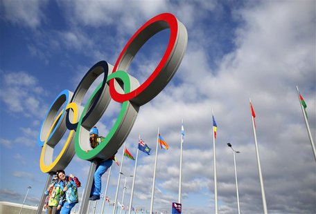 Volunteers pose for a photograph in the Olympic Rings ahead of the 2014 Sochi Winter Olympics, February 6, 2014. REUTERS/Issei Kato Volunteers pose for a photograph in the Olympic Rings ahead of the 2014 Sochi Winter Olympics, February 6, 2014. REUTERS/Issei Kato