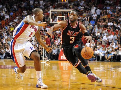 Feb 3, 2014; Miami, FL, USA; Miami Heat shooting guard Dwyane Wade (3) drives to the basket as Detroit Pistons shooting guard Kentavious Cal Feb 3, 2014; Miami, FL, USA; Miami Heat shooting guard Dwyane Wade (3) drives to the basket as Detroit Pistons shooting guard Kentavious Cal