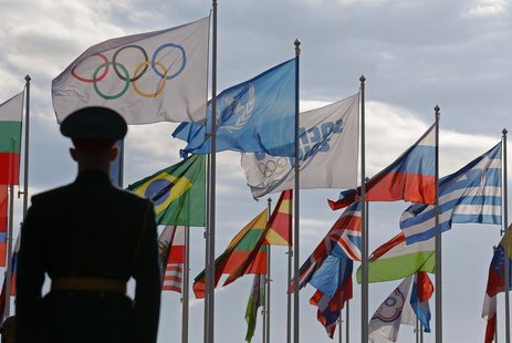 A Russian soldier stands in front of the flags during the welcoming ceremony for the U.S Olympic team in the Athletes Village at the Olympic A Russian soldier stands in front of the flags during the welcoming ceremony for the U.S Olympic team in the Athletes Village at the Olympic