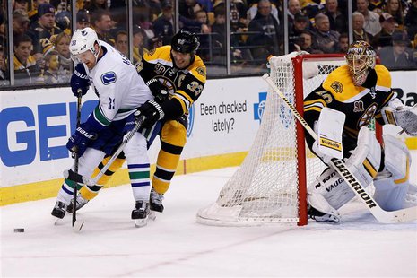 Feb 4, 2014; Boston, MA, USA; Vancouver Canucks center Henrik Sedin (33) battles with Boston Bruins defenseman Zdeno Chara (33) behind the n Feb 4, 2014; Boston, MA, USA; Vancouver Canucks center Henrik Sedin (33) battles with Boston Bruins defenseman Zdeno Chara (33) behind the n