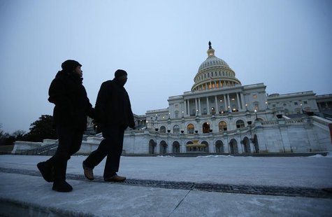 Pedestrians walk past the U.S. Capitol building prior to U.S. President Barack Obama's State of the Union address in front of the U.S. Congr Pedestrians walk past the U.S. Capitol building prior to U.S. President Barack Obama's State of the Union address in front of the U.S. Congr