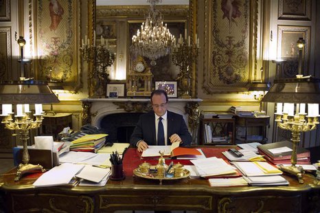 French President Francois Hollande works in his office during a photo session at the Elysee Palace in Paris, in this December 17, 2012 file French President Francois Hollande works in his office during a photo session at the Elysee Palace in Paris, in this December 17, 2012 file