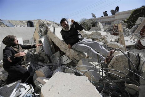 A Palestinian man reacts as he sits atop rubble after his home was demolished in Jabel Mukaber, a village in the suburbs of East Jerusalem, A Palestinian man reacts as he sits atop rubble after his home was demolished in Jabel Mukaber, a village in the suburbs of East Jerusalem,
