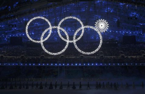 Participants march by as one of the Olympic Rings fails to completely illuminate during the opening ceremony of the 2014 Sochi Winter Olympi Participants march by as one of the Olympic Rings fails to completely illuminate during the opening ceremony of the 2014 Sochi Winter Olympi