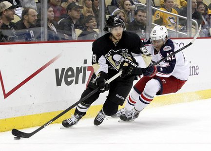 Dec 9, 2013; Pittsburgh, PA, USA; Pittsburgh Penguins defenseman Kris Letang (58) handles the puck against pressure from Columbus Blue Jacke Dec 9, 2013; Pittsburgh, PA, USA; Pittsburgh Penguins defenseman Kris Letang (58) handles the puck against pressure from Columbus Blue Jacke