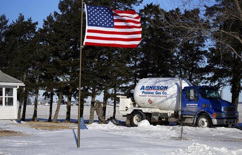 Arenson Oil and Propane delivery driver Don Bedford pulls the hose to fill up empty propane tanks in Sandwich, Illinois January 29, 2014. RE Arenson Oil and Propane delivery driver Don Bedford pulls the hose to fill up empty propane tanks in Sandwich, Illinois January 29, 2014. RE