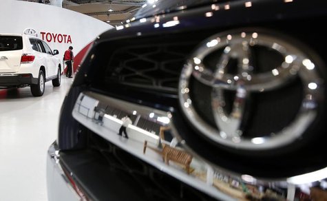 A showroom staff member works under the logo of Toyota Motor Corp, between cars displayed at its showroom in Tokyo February 4, 2014. REUTERS A showroom staff member works under the logo of Toyota Motor Corp, between cars displayed at its showroom in Tokyo February 4, 2014. REUTERS