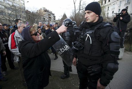 A protester speaks to a police officer in front of a government building in Sarajevo February 8, 2014. REUTERS/Antonio Bronic A protester speaks to a police officer in front of a government building in Sarajevo February 8, 2014. REUTERS/Antonio Bronic
