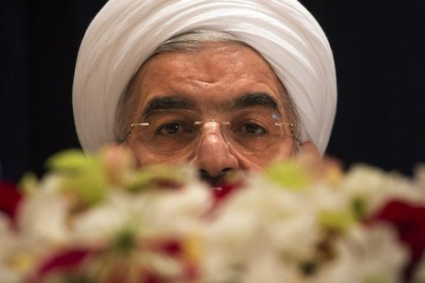 Iran's President Hassan Rouhani takes questions from journalists past a bouquet of flowers at a news conference in New York September 27, 20 Iran's President Hassan Rouhani takes questions from journalists past a bouquet of flowers at a news conference in New York September 27, 20