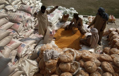 Labourers pack lentils at a distribution point for internally displaced persons (IDPs) in Dera Ismail Khan, Pakistan's restive North West Fr Labourers pack lentils at a distribution point for internally displaced persons (IDPs) in Dera Ismail Khan, Pakistan's restive North West Fr