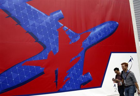 People walk past a Singapore Airshow poster at the exhibition venue in Singapore February 7, 2014. REUTERS/Edgar Su People walk past a Singapore Airshow poster at the exhibition venue in Singapore February 7, 2014. REUTERS/Edgar Su