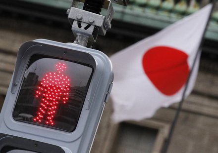 A "Don't Walk" traffic signal is seen in front of the national flag hoisted on the headquarters of Bank of Japan in Tokyo February 8, 2012. A "Don't Walk" traffic signal is seen in front of the national flag hoisted on the headquarters of Bank of Japan in Tokyo February 8, 2012.