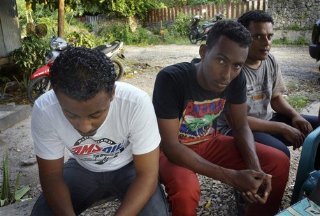Asylum seekers, who were turned back by Australia, sit in an immigration holding area at a hotel in Kupang January 28, 2014. REUTERS/Aubrey Asylum seekers, who were turned back by Australia, sit in an immigration holding area at a hotel in Kupang January 28, 2014. REUTERS/Aubrey