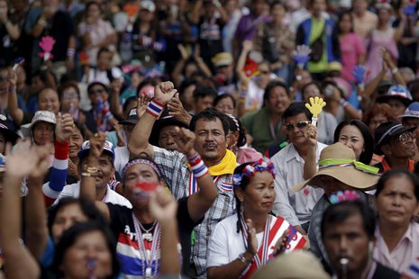 Anti-government protesters react as they listen to a leader's speech at an intersection protesters are occupying in downtown Bangkok Februar Anti-government protesters react as they listen to a leader's speech at an intersection protesters are occupying in downtown Bangkok Februar