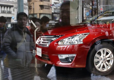 Nissan Motor's Teana sedan is displayed as pedestrians are reflected in a window at the company's showroom in Tokyo February 10, 2014. REUTE Nissan Motor's Teana sedan is displayed as pedestrians are reflected in a window at the company's showroom in Tokyo February 10, 2014. REUTE