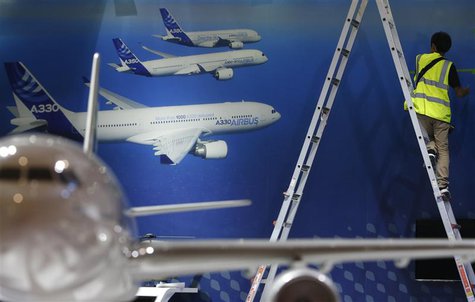 A worker makes final touches to the Airbus booth ahead of the Singapore Airshow February 10, 2014. REUTERS/Edgar Su A worker makes final touches to the Airbus booth ahead of the Singapore Airshow February 10, 2014. REUTERS/Edgar Su