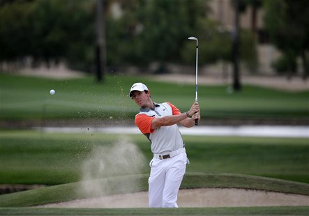 Rory McIlroy of Northern Ireland hits the ball out of the bunker on the 13th hole during the final round of the 2014 Omega Dubai Desert Clas Rory McIlroy of Northern Ireland hits the ball out of the bunker on the 13th hole during the final round of the 2014 Omega Dubai Desert Clas