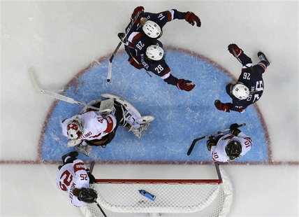 Team USA's Kendall Coyne (26) celebrates her goal with teammates Amanda Kessel (28) and Brianna Decker as Switzerland's goalie Florence Sche Team USA's Kendall Coyne (26) celebrates her goal with teammates Amanda Kessel (28) and Brianna Decker as Switzerland's goalie Florence Sche