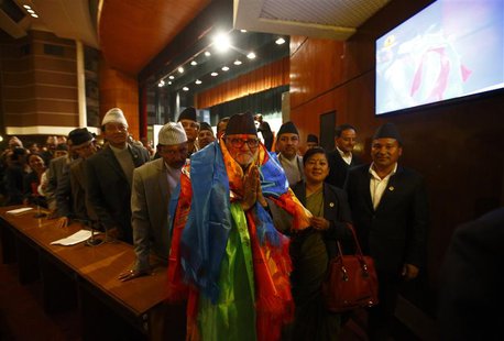 Newly elected Nepalese Prime Minister Sushil Koirala greets media personnel as he walks out from the Parliament after being elected as the P Newly elected Nepalese Prime Minister Sushil Koirala greets media personnel as he walks out from the Parliament after being elected as the P