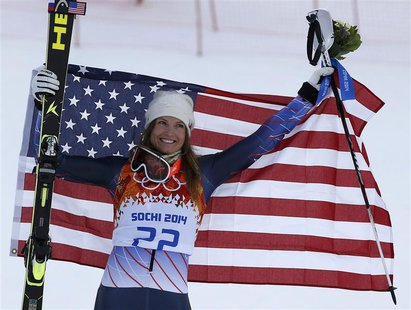 Third-placed Julia Mancuso of the U.S. celebrates with a U.S. flag during the flower ceremony after the women's alpine skiing super combined Third-placed Julia Mancuso of the U.S. celebrates with a U.S. flag during the flower ceremony after the women's alpine skiing super combined