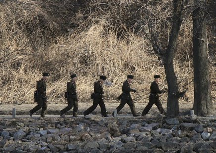 North Korean soldiers patrol along the bank of Yalu River near the North Korean town of Sinuiju, opposite the Chinese border city of Dandong North Korean soldiers patrol along the bank of Yalu River near the North Korean town of Sinuiju, opposite the Chinese border city of Dandong