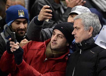 Chelsea manager Jose Mourinho (R) has his photograph taken with fans before their English Premier League soccer match against Manchester Cit Chelsea manager Jose Mourinho (R) has his photograph taken with fans before their English Premier League soccer match against Manchester Cit