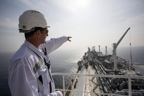 An officer points as he stands on a tanker carrying liquefied natural gas in the Mediterranean, some 10 km (6 miles) from the coastal Israel An officer points as he stands on a tanker carrying liquefied natural gas in the Mediterranean, some 10 km (6 miles) from the coastal Israel