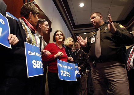LGBT rights activists are arrested by members of the Utah Highway Patrol after blocking a Senate committee hearing room at the Utah State Ca LGBT rights activists are arrested by members of the Utah Highway Patrol after blocking a Senate committee hearing room at the Utah State Ca