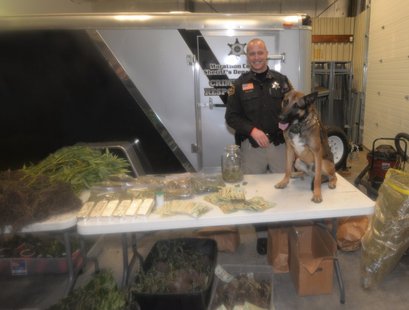 Marathon County Deputy Sheriff Brandon Stroik and his K-9 partner Csibi pose with drugs seized in a series of arrests, February 10 2014 Marathon County Deputy Sheriff Brandon Stroik and his K-9 partner Csibi pose with drugs seized in a series of arrests, February 10 2014