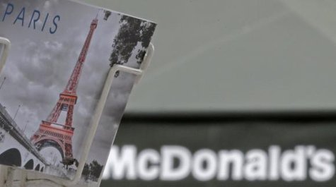 A postcard showing the Paris city landmark, the Eiffel Tower, is seen in front of a McDonald's fast-food restaurant in Paris, January 22, 2014.
CREDIT: REUTERS/CHRISTIAN HARTMANN A postcard showing the Paris city landmark, the Eiffel Tower, is seen in front of a McDonald's fast-food restaurant in Paris, January 22, 2014.
CREDIT: REUTERS/CHRISTIAN HARTMANN