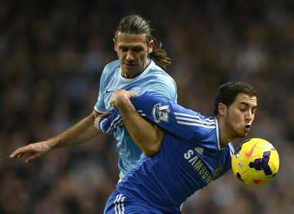 Chelsea's Eden Hazard (R) is challenged by Manchester City's Martin Demichelis during their English Premier League soccer match at the Etiha Chelsea's Eden Hazard (R) is challenged by Manchester City's Martin Demichelis during their English Premier League soccer match at the Etiha