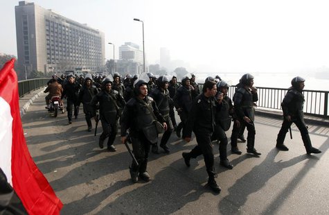 Riot police are seen on October bridge during clashes with anti-government protesters and members of the Muslim Brotherhood, near Tahrir Squ Riot police are seen on October bridge during clashes with anti-government protesters and members of the Muslim Brotherhood, near Tahrir Squ