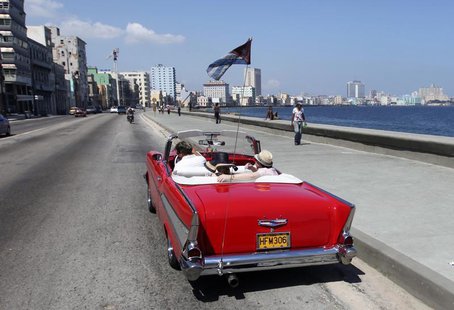 Tourists ride a U.S.-made 1957 Chevrolet Bel-Air convertible car on Havana's seafront boulevard 'El Malecon' May 21, 2013. REUTERS/Desmond B Tourists ride a U.S.-made 1957 Chevrolet Bel-Air convertible car on Havana's seafront boulevard 'El Malecon' May 21, 2013. REUTERS/Desmond B