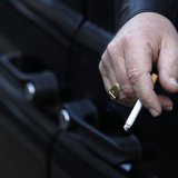 A man smokes in his car in London November 16, 2011. REUTERS/Suzanne Plunkett A man smokes in his car in London November 16, 2011. REUTERS/Suzanne Plunkett