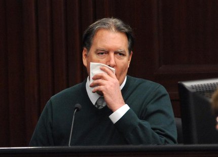 Defendant Michael Dunn, is shown in a television monitor as he reacts on the stand during testimony in his own defense during his murder tri Defendant Michael Dunn, is shown in a television monitor as he reacts on the stand during testimony in his own defense during his murder tri