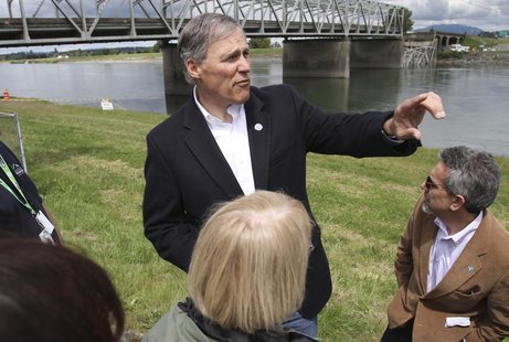 Washington State Governor Jay Inslee looks over the scene as a span of highway bridge sits in the Skagit River May 24, 2013 after collapsing Washington State Governor Jay Inslee looks over the scene as a span of highway bridge sits in the Skagit River May 24, 2013 after collapsing