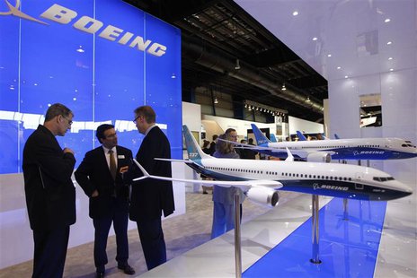 Visitors talk at the Boeing booth at the Singapore Airshow February 11, 2014. REUTERS/Edgar Su Visitors talk at the Boeing booth at the Singapore Airshow February 11, 2014. REUTERS/Edgar Su