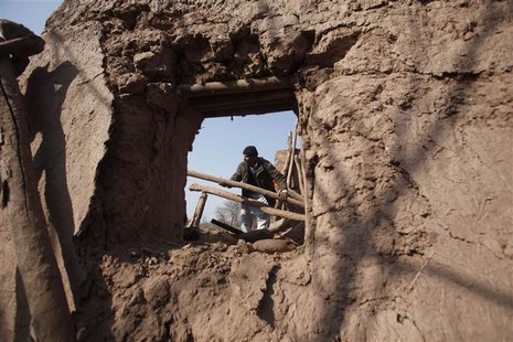 A resident collects items from the rubble of a house after it was damaged by grenades from gunmen on the outskirts of the northwestern city A resident collects items from the rubble of a house after it was damaged by grenades from gunmen on the outskirts of the northwestern city