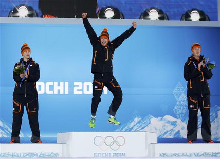 Gold medalist Sven Kramer (C) of the Netherlands jumps on the podium next to his compatriots silver medalist Jan Blokhuijsen (L) and bronze Gold medalist Sven Kramer (C) of the Netherlands jumps on the podium next to his compatriots silver medalist Jan Blokhuijsen (L) and bronze