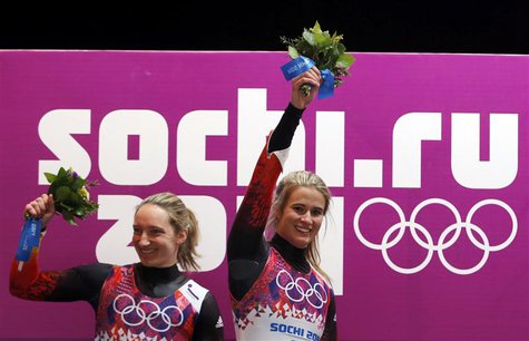 Winner Germany's Natalie Geisenberger (R) and second-placed compatriot Tatjana Huefner celebrate with their bouquets at the flower ceremony Winner Germany's Natalie Geisenberger (R) and second-placed compatriot Tatjana Huefner celebrate with their bouquets at the flower ceremony