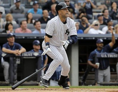 New York Yankees batter Derek Jeter drops the bat and watches the ball as he hits a two-run home run on the first pitch from Tampa Bay Rays New York Yankees batter Derek Jeter drops the bat and watches the ball as he hits a two-run home run on the first pitch from Tampa Bay Rays